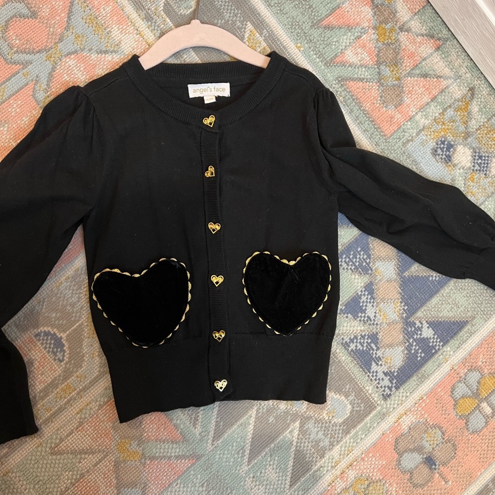Black Angel’s Face cardigan sweater with gold trim